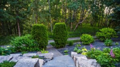 Stone steps to a garden with landscaping. Photo